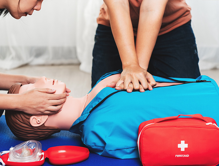 Student practicing first aid on a dummy